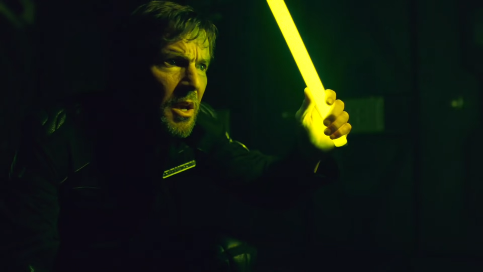 character holds a glowing nightstick in the dark