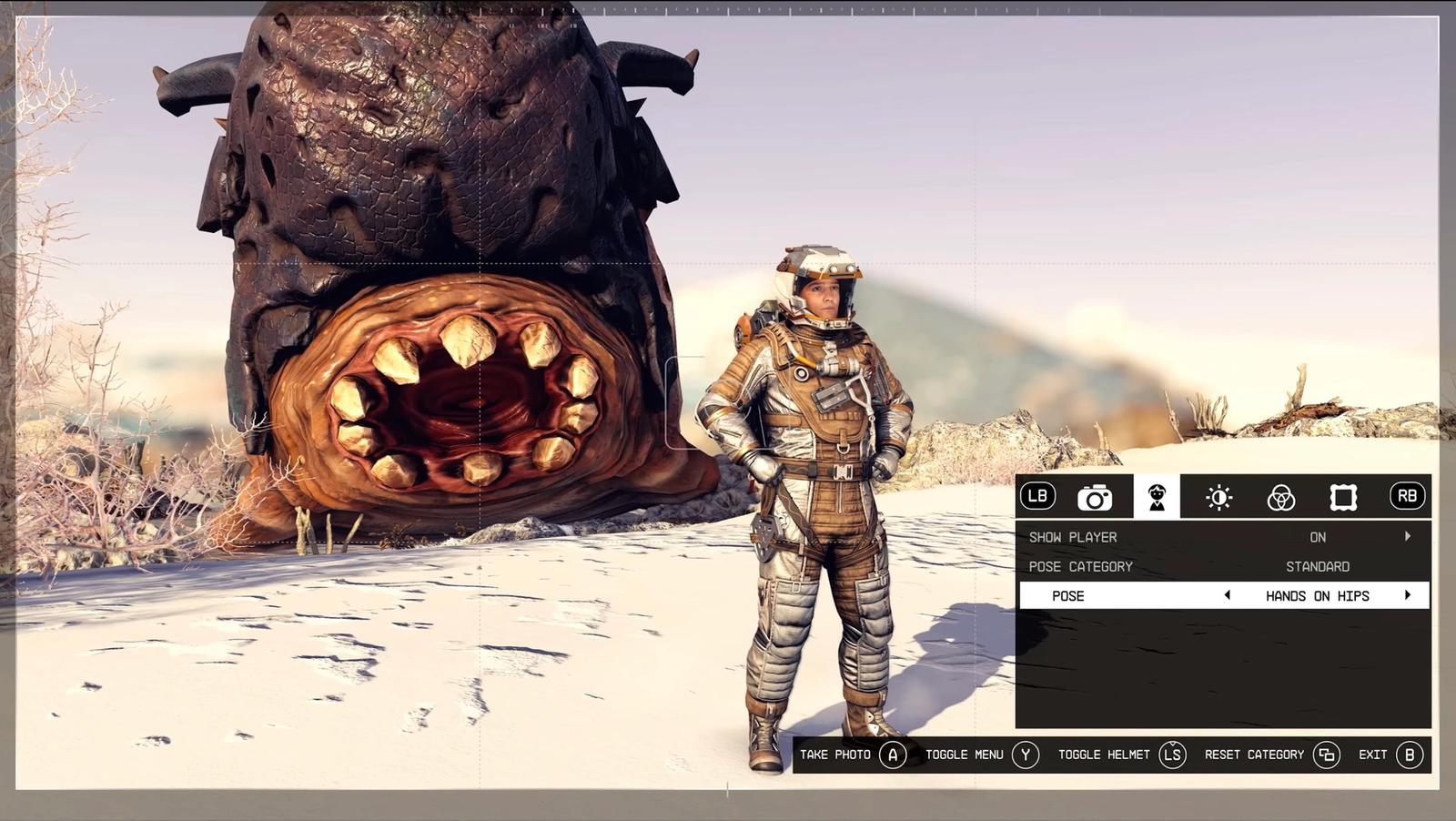 Player poses in front of a giant toothy alien