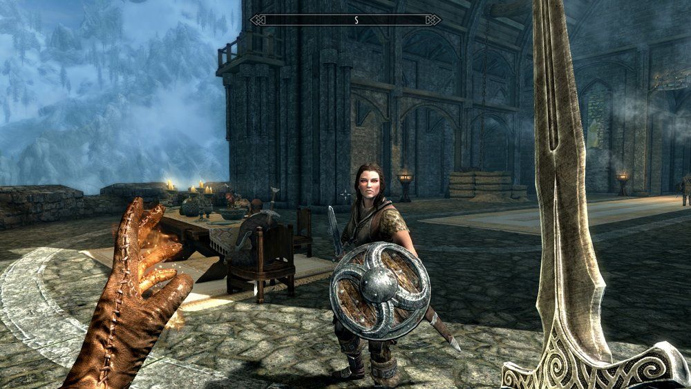 skyrim combat with magic in left hand and sword in right hand facing enemy with shield