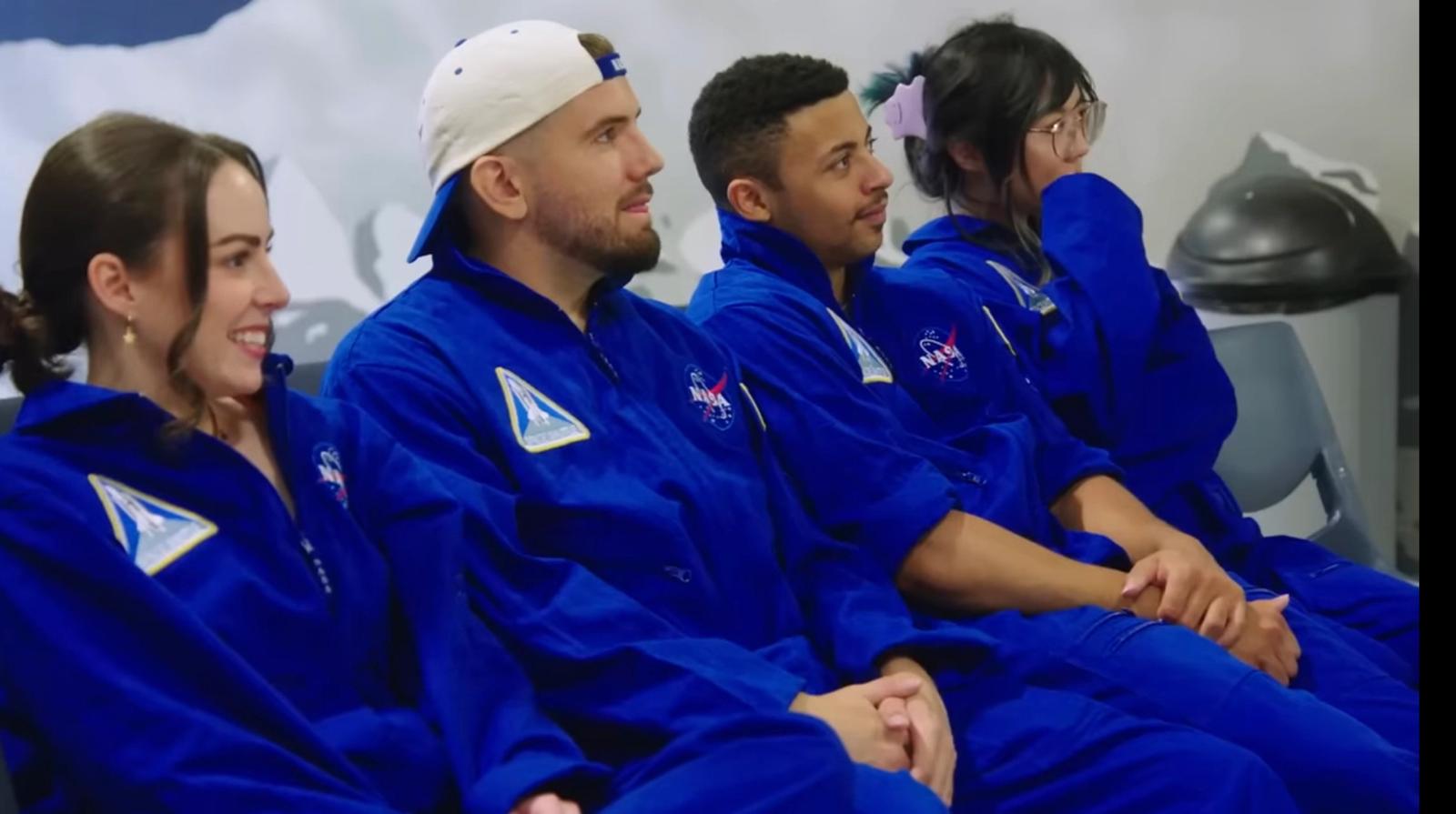 Four content creators in space training gear
